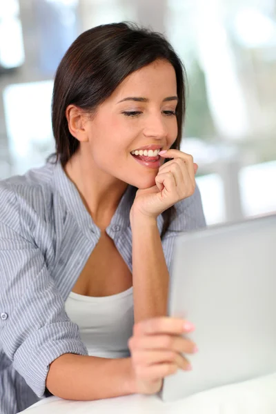 Young woman at home using electronic tablet Royalty Free Stock Images