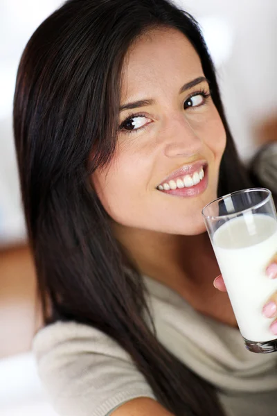 Attractive young woman drinking fresh milk Royalty Free Stock Images