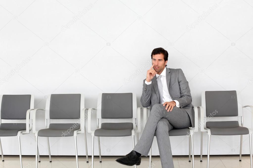 Businessman sitting in airport waiting room