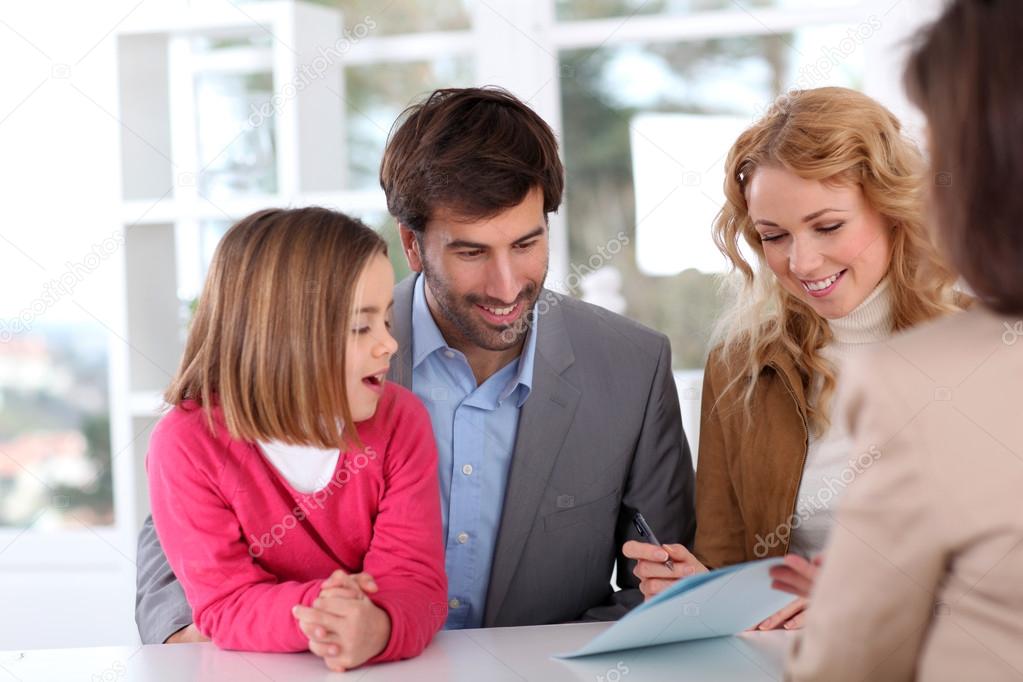 Family signing real-estate contract