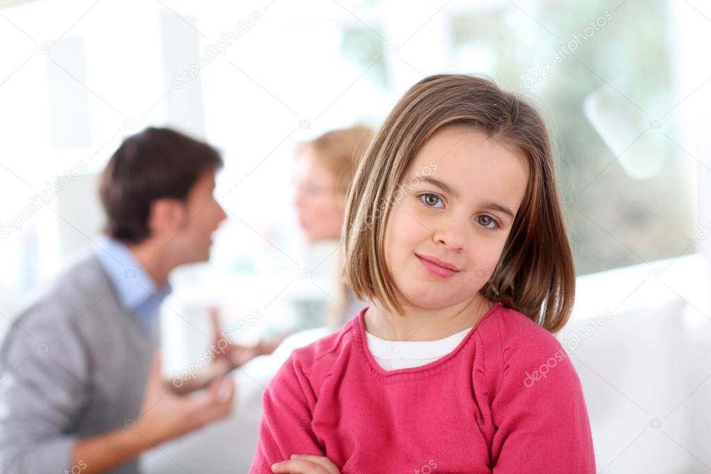 Portrait of upset child with parent's fighting