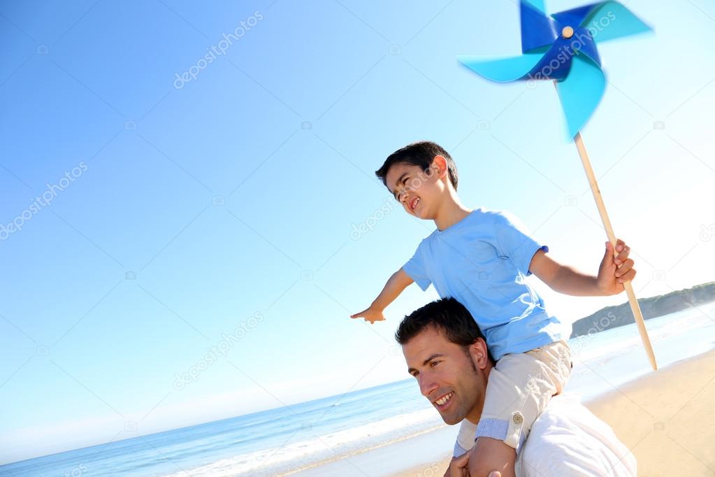Little boy up on his fathers's shoulders holding swirl