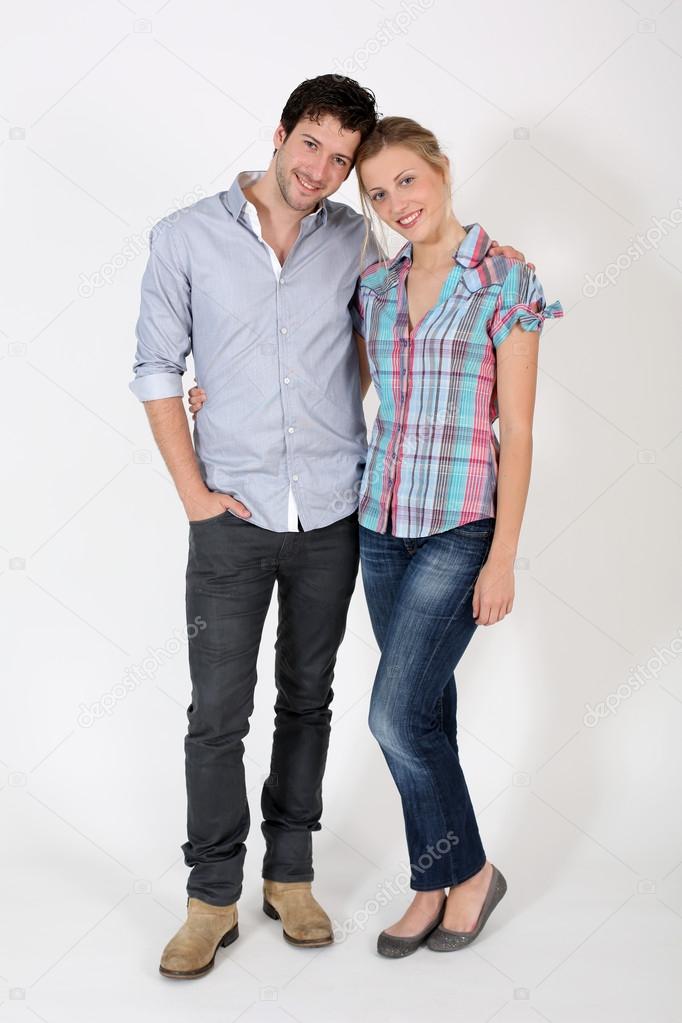 Young cute couple standing on white background