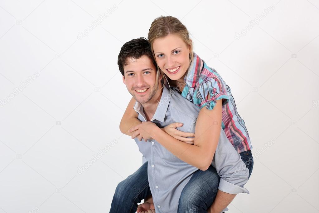 Young man carrying girlfriend on his back ? Stock Photo, I photo
