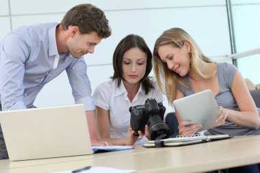 Team of photo reporters working in office clipart