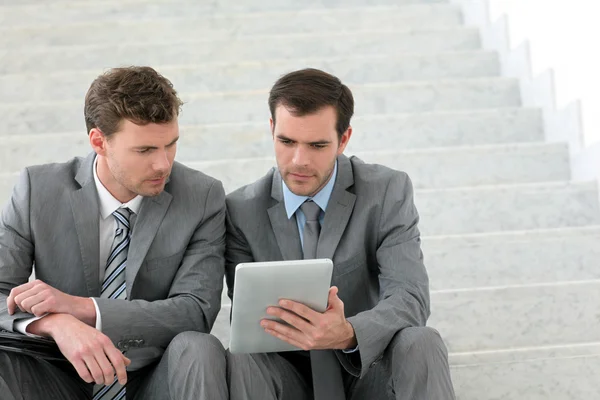 Business meeting in stairs with electronic tablet — Stock Photo, Image