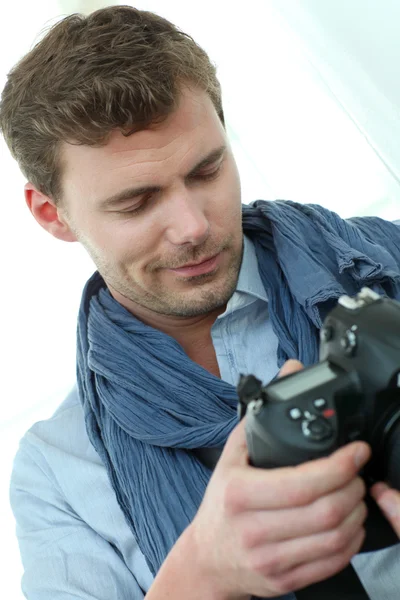 Handsome guy holding photo camera — Stock Photo, Image