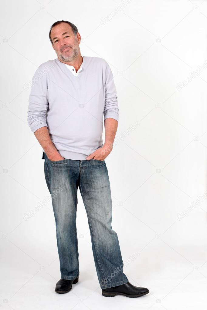 Senior man standing on white background with ignoring look
