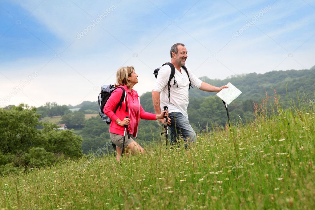 Senior couple hiking in natural landscape