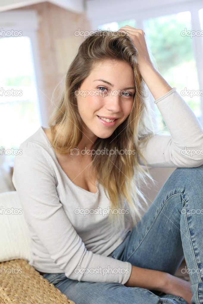 Portrait of beautiful blond woman relaxing in sofa