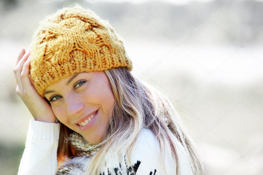 Portrait of blond woman in winter clothes and accessories