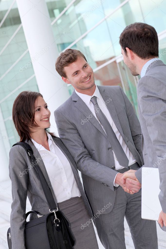 Business meeting outside office building