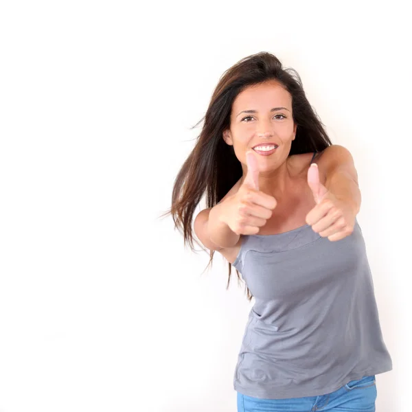 Charming young woman showing thumbs up, isolated — Stockfoto