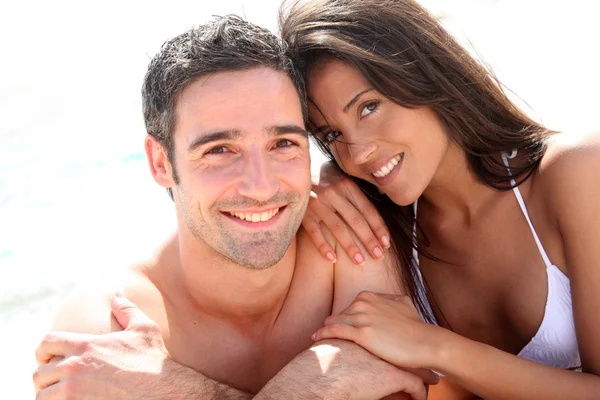 Portrait of romantic couple laying on the beach — Stock Image Portrait of romantic couple laying on the beach Stock Photo