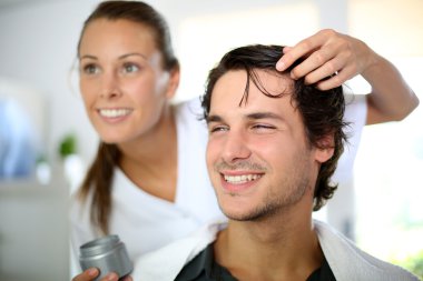 Hairdresser applying hair gel clipart