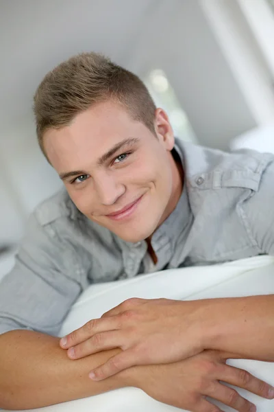 Portrait of handsome guy sitting in sofa — Stock Photo, Image