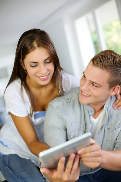 Young couple websurfing on electronic tablet — Stock Photo, Image