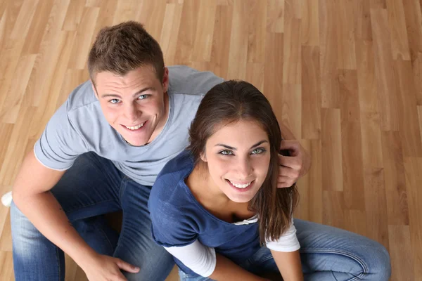 Upper view of young couple sitting on the floor — Stock Photo, Image