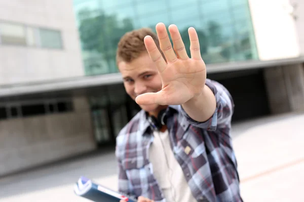 Student weergegeven: hand naar camera — Stockfoto