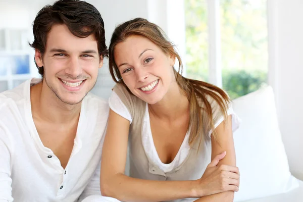 Portrait of smiling young couple at home — Stock Photo, Image