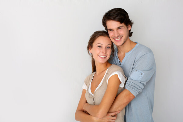 Cheerful young couple standing on white background, isolated