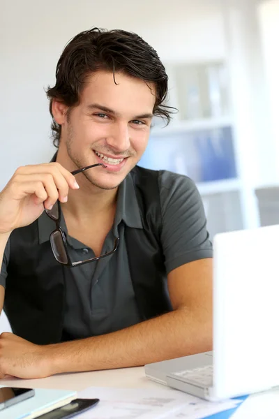 Porträtt av ung man arbetar på kontor — Stockfoto