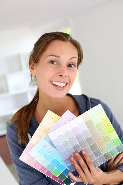 Retrato de niña sonriente mostrando cartas de colores para decorar la casa —  Fotos de Stock