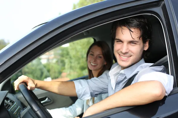 Cheerful couple driving car — Stock Photo, Image