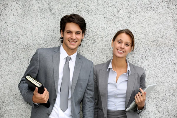 Cheerful business standing on grey background — Stock Photo, Image