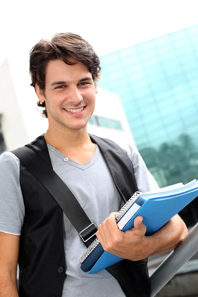 Cheerful student standing outside college building — Stock Photo, Image