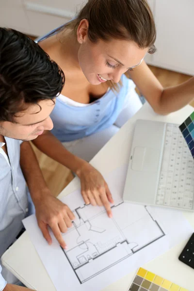 Upper view of couple looking at blueprint Stock Picture