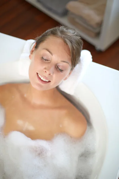 Woman with eyes shut in bathtub Royalty Free Stock Images