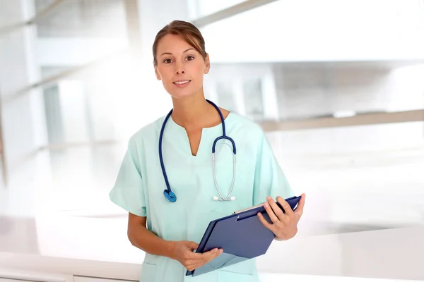 Portrait of beautiful nurse standing in hospital Royalty Free Stock Images