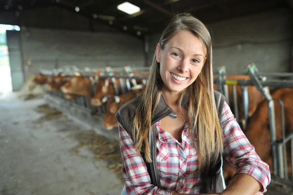 Portrait of woman working in barn Stock Picture