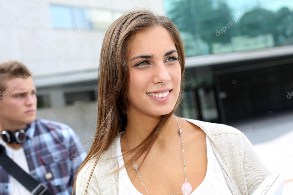 Portrait of student girl walking on university campus