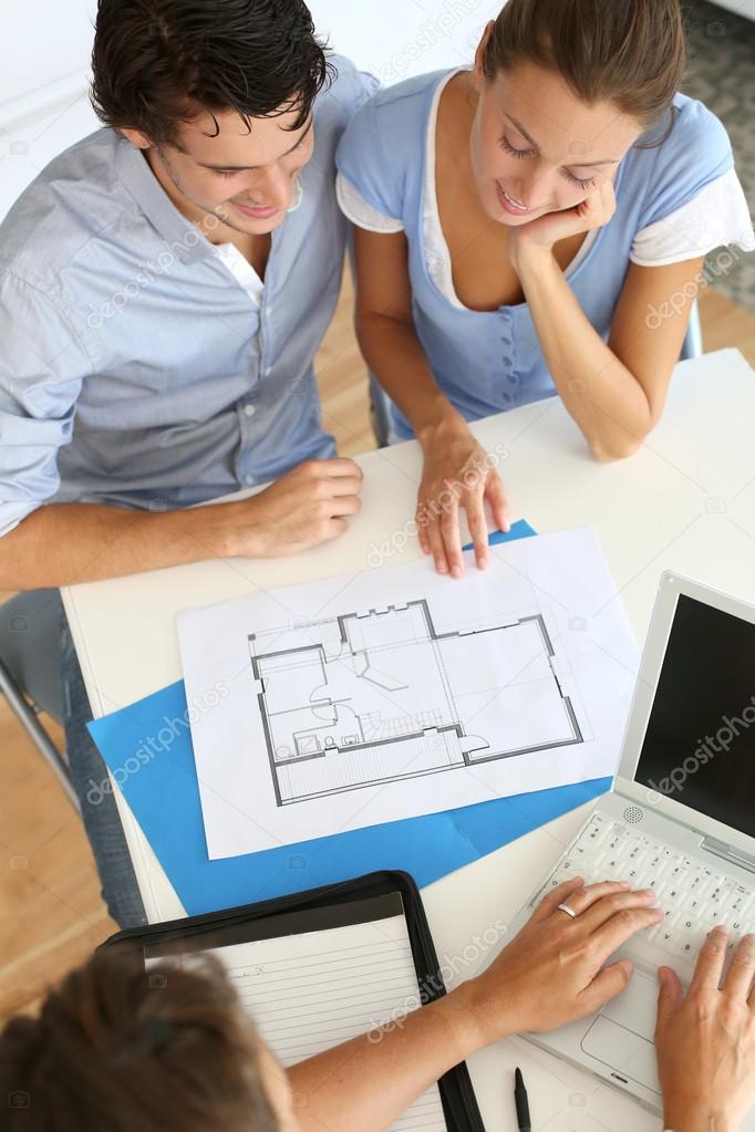 Couple meeting architect for plans of future home