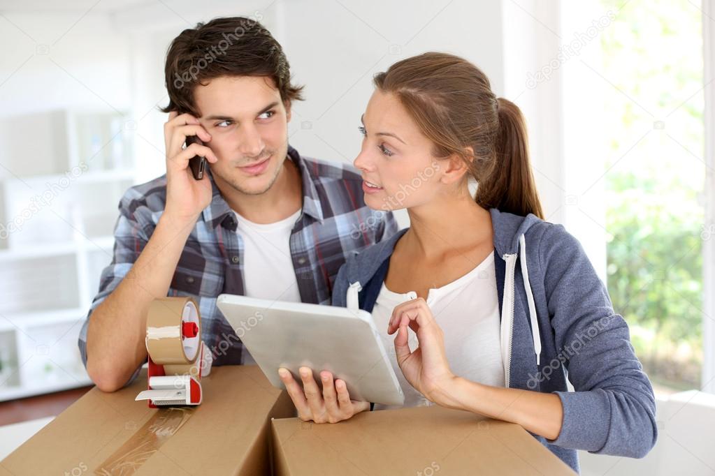 Couple calling transport company to move in new house
