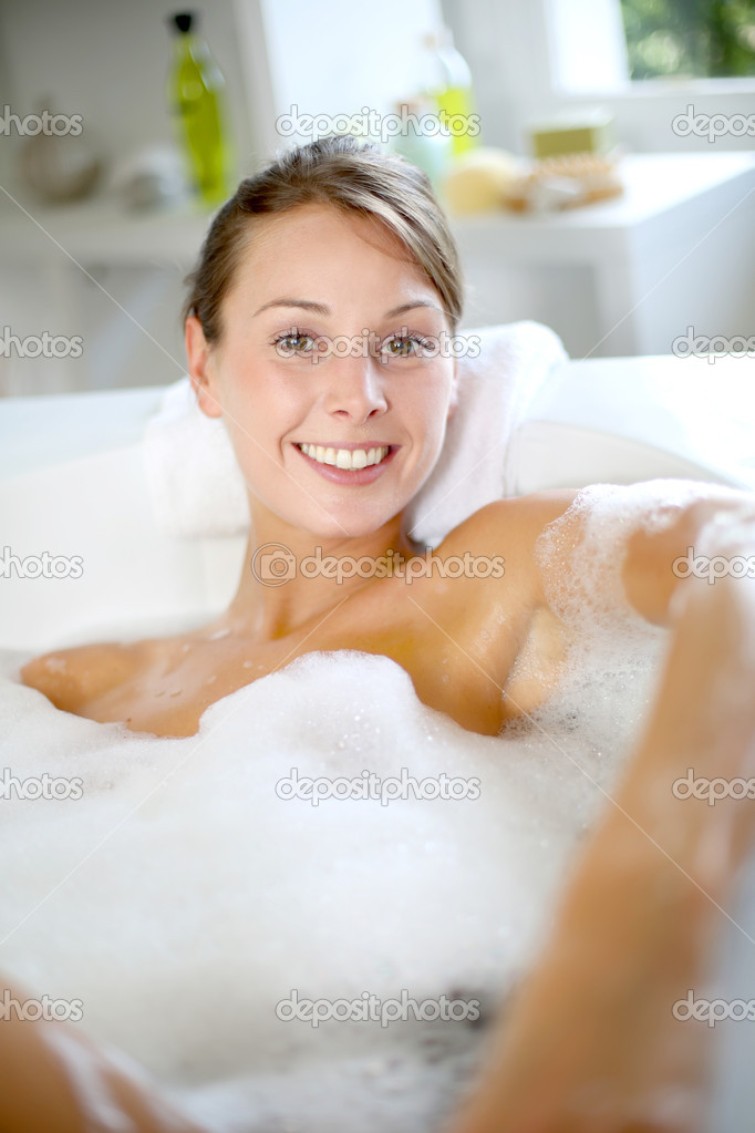 Cheerful young woman enjoying bath time
