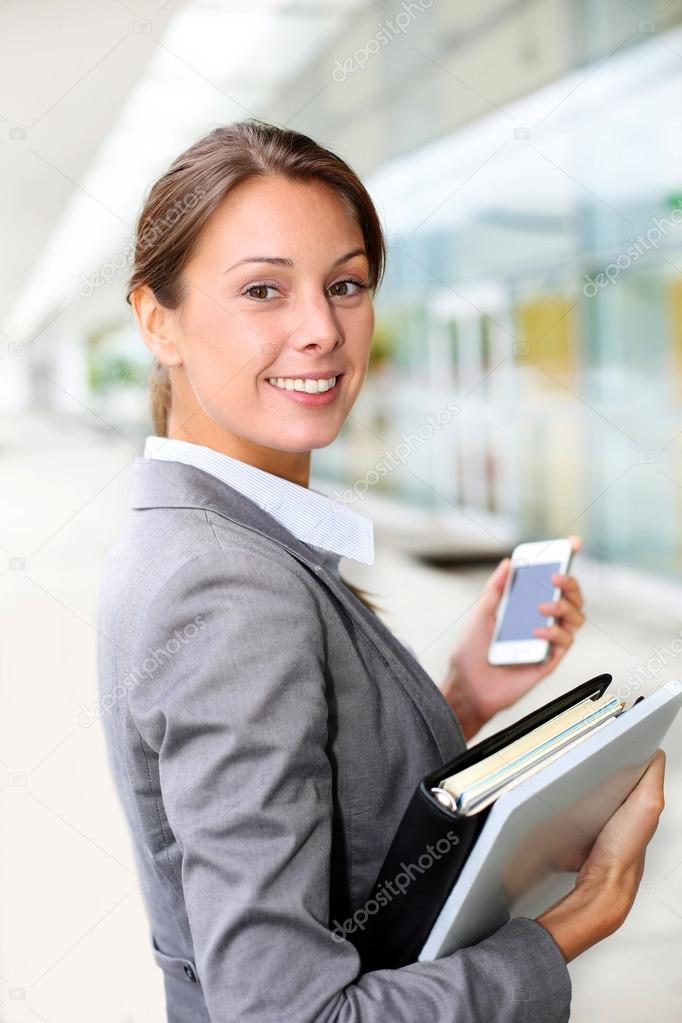 Attractive businesswoman standing outside