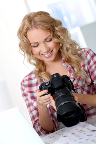 Photographer looking at photo camera — Stock Photo, Image