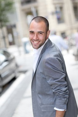 neşeli genç adam şehirde yürüyüş