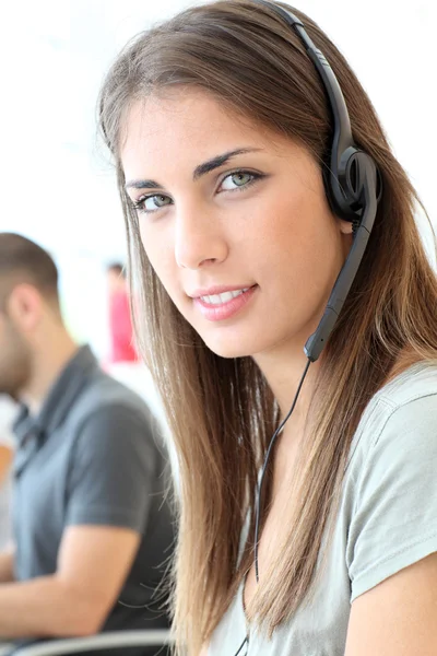 Portrait of customer service woman with headphones — Stock Photo, Image