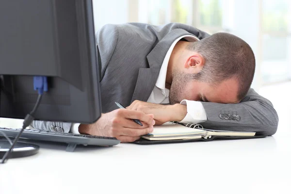 Portrait of exhausted businessman in office — Stock Photo, Image