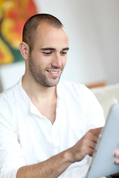 Closeup of handsome man websurfing on touchpad — Stock Photo, Image