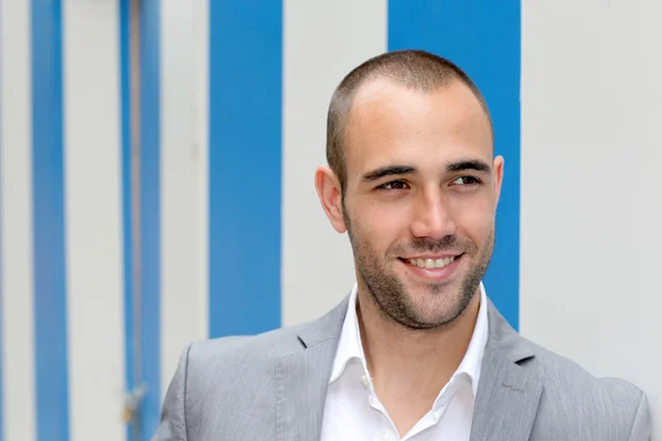 Portrait of cool businessman standing in town — Stock Photo, Image