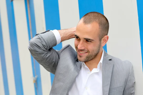 Portrait of cool businessman standing in town — Stock Photo, Image