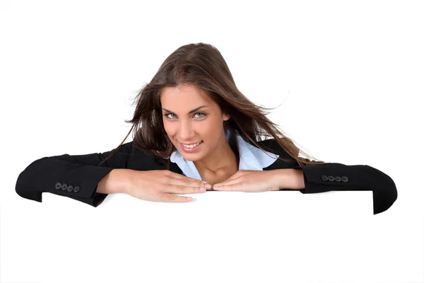 Smiling businesswoman holding whiteboard — Stock Photo, Image