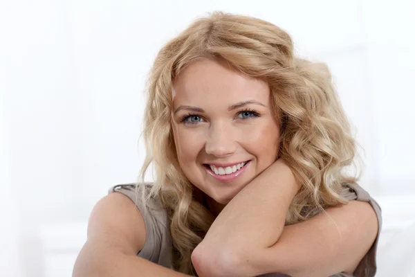 Portrait of beautiful blond woman relaxing at home Stock Photo