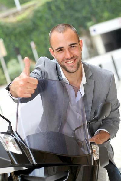 Man going to work on motorcycle Stock Image