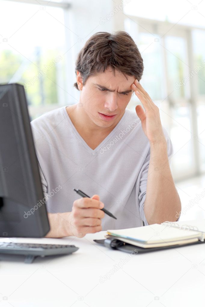 Portrait of office worker having a headache at work